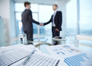 two businessmen shaking hands during a meeting
