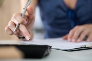 Close up of female accountant or banker making calculations